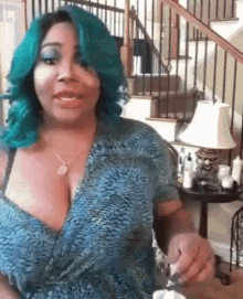 a woman with blue hair is sitting in front of stairs and a lamp