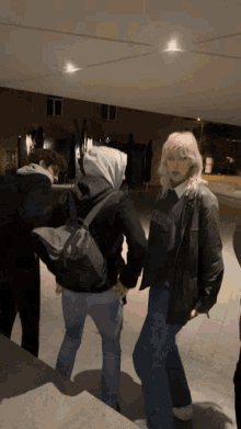 a girl wearing a black sweatshirt that says army
