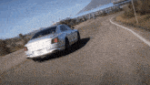 a white bentley is driving down a road with a california license plate that says lxds