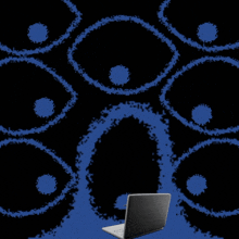 a laptop is sitting in front of a black and blue background