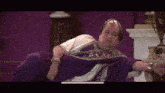 a man dressed as a roman emperor is laying down