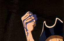 a cartoon character with a pirate hat is holding up his fist and his fingers are painted blue