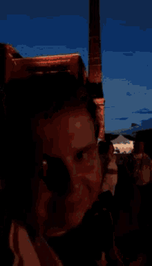 a blurry picture of a man standing in the dark