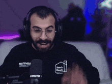 a man wearing headphones and a shirt that says natives on it