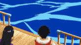 a man and a woman on a boat looking out over the ocean