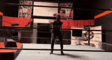 a man is standing in a boxing ring with a sign that says escape on it