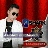 a man wearing sunglasses stands in front of a red curtain with the word shark on it