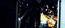 a man is standing in front of a window holding a knife .