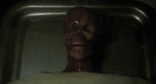 a person is laying on a bed with their eyes closed and a hand on their face .