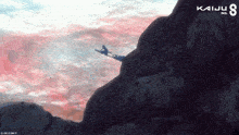 a poster for kaiju no 8 shows a person riding a skateboard down a cliff