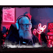 a man with a beard wearing headphones in front of a scream mask