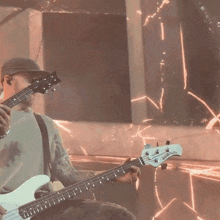 a man is playing a bass guitar with a white headstock