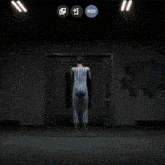 a person is holding a gun in a dark room and a woman is standing in the background .
