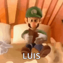 a cartoon character is sitting on a bed with the word luis written on the bottom .