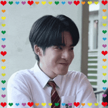 a young man in a white shirt and tie is surrounded by colorful hearts including one that says ' a '