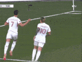 two soccer players on a field with one wearing number 10