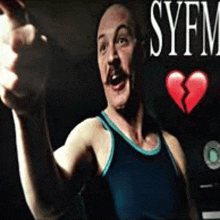 a man with a mustache is pointing at the camera and has a broken heart in the background .