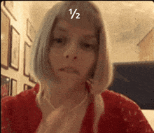 a close up of a woman 's face with the number 1/2 on it