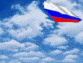a russian flag is waving in the wind against a blue cloudy sky