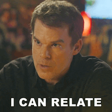 a man in a black shirt says " i can relate " in white letters