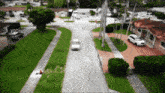 a white car is driving down a residential road