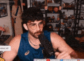 a man talking into a microphone with the words indica vs sativa horny in the background