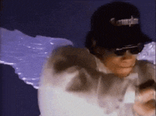 a man wearing sunglasses and a hat that says compton