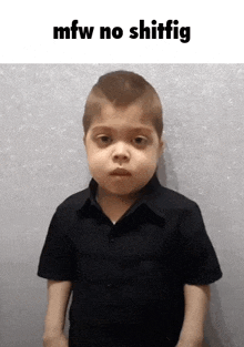a young boy in a black shirt is standing in front of a wall with the words mfw no shitfig written above him .