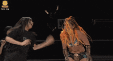 a woman with orange hair is fighting a man wearing a shirt that says digi.n