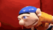 a cartoon character wearing a blue hat and a yellow shirt .