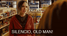 a woman in a red jacket is standing in a store and says silencio old man