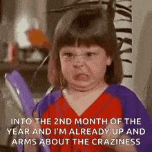 a little girl is making a funny face and making a funny face in the 2nd month of the year .