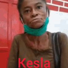 a woman wearing a green mask with the name kesla written on it