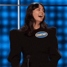 a woman with a name tag that says courtney is laughing