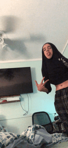 a person with long hair giving the middle finger