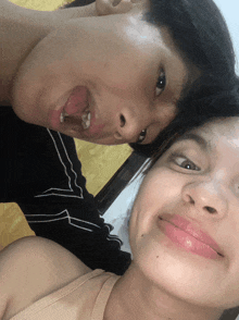a man and a woman are posing for a picture and the woman is wearing pink lipstick