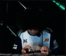 a man wearing a shirt that says carnet on it is playing a video game .