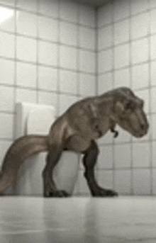 a t-rex is standing on a toilet in a bathroom .