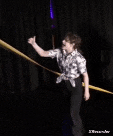 a girl in a purple shirt is dancing with another girl