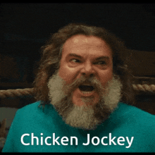 a man with a beard and long hair is wearing a blue shirt that says chicken jockey on it