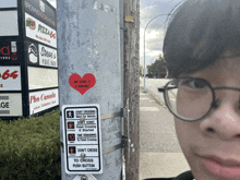 a person wearing glasses is standing next to a sign that says " do n't cross to cross "
