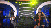 a couple of wrestlers on a stage with a tnt logo in the corner