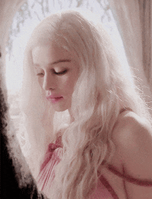 a close up of a woman with blonde hair and pink lips