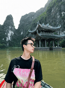 a man wearing a black t-shirt that says paradise