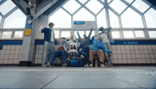 a group of people are standing in front of a sign that says ' subway ' on it