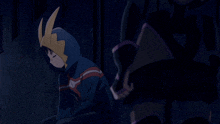 a man in a hoodie with a yellow horn on his head is sitting in the dark
