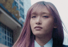 a close up of a woman with purple hair