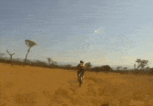 a person riding a motorcycle through a field