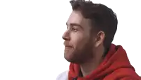 a man with a beard wearing a red hoodie looks to the side