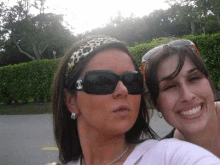 two women wearing sunglasses and a headband with a chanel logo on it